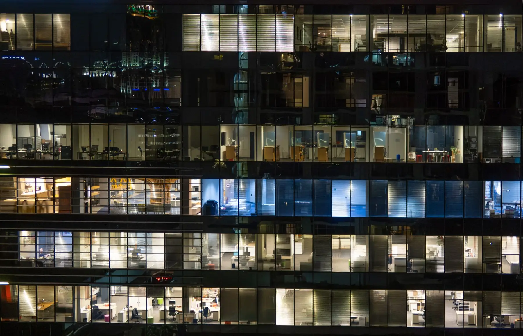 Office towers at night, every floor lit